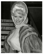 Sabrina in fur and white ribbon at an Australian Airport - probably 1958.